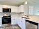 Modern kitchen featuring stainless steel appliances, white cabinets, and quartz countertops at 7702 Brisbane Ct, Charlotte, NC 28215