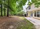 Backyard, featuring a patio, mature trees, and a wooden fence at 7713 Dunoon Ln, Charlotte, NC 28269