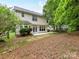 Spacious yard with a patio and a wooded fence line at 7713 Dunoon Ln, Charlotte, NC 28269