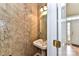 Powder room features pedestal sink, textured wallpaper, and a decorative light fixture at 7713 Dunoon Ln, Charlotte, NC 28269