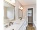Elegant bathroom featuring a double sink vanity with marble countertop and gold fixtures at 7713 Dunoon Ln, Charlotte, NC 28269