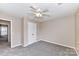 Neutral bedroom featuring carpet, neutral walls, and a closet with a white door at 7713 Dunoon Ln, Charlotte, NC 28269