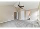 Spacious carpeted bedroom with vaulted ceiling, fan, and multiple closets for storage at 7713 Dunoon Ln, Charlotte, NC 28269