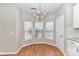 Bright breakfast nook featuring a chandelier and bay windows overlooking the yard at 7713 Dunoon Ln, Charlotte, NC 28269
