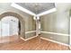 Open concept dining room featuring tray ceilings, decorative walls, and hardwood floors at 7713 Dunoon Ln, Charlotte, NC 28269
