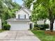 Charming two-story home with a well-maintained lawn and a two-car garage at 7713 Dunoon Ln, Charlotte, NC 28269