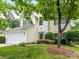 Two-story home with green shutters, landscaping, and a two-car garage at 7713 Dunoon Ln, Charlotte, NC 28269