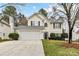 Charming two-story home featuring a two-car garage, well-maintained lawn, and a welcoming facade at 7713 Dunoon Ln, Charlotte, NC 28269