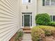 View of the front door with decorative trim and a green paint color at 7713 Dunoon Ln, Charlotte, NC 28269