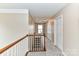 Well-lit hallway with carpet flooring, neutral paint, and access to multiple rooms at 7713 Dunoon Ln, Charlotte, NC 28269