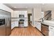 Bright kitchen with stainless steel appliances, granite countertops, and tile backsplash at 7713 Dunoon Ln, Charlotte, NC 28269
