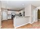 Kitchen with white cabinets, stainless steel appliances, and a breakfast bar overlooking the dining area at 7713 Dunoon Ln, Charlotte, NC 28269