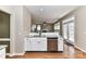 Open kitchen with white cabinets, stainless steel dishwasher, and granite countertops at 7713 Dunoon Ln, Charlotte, NC 28269