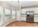 Eat-in kitchen featuring a stainless steel refrigerator and a breakfast nook with large windows at 7713 Dunoon Ln, Charlotte, NC 28269