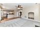 Open-concept living area with hardwood floors, a fireplace, and a view into the kitchen at 7713 Dunoon Ln, Charlotte, NC 28269