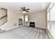 Cozy living room with fireplace, built-in shelving, and large windows for ample natural light at 7713 Dunoon Ln, Charlotte, NC 28269