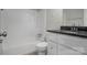 Well-lit bathroom featuring a shower-tub combo and granite-topped vanity at 821 Cabaniss Dr, Shelby, NC 28150