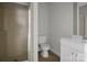 Bathroom with a glass shower, toilet and vanity with white cabinets at 821 Cabaniss Dr, Shelby, NC 28150