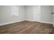 Bedroom featuring wood-look flooring, window, door, and neutral walls at 821 Cabaniss Dr, Shelby, NC 28150