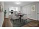 Virtually staged dining area connecting the kitchen and eating space, complete with a modern table setting and a potted plant at 821 Cabaniss Dr, Shelby, NC 28150