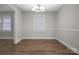Open dining room with hardwood floors, and a modern chandelier at 821 Cabaniss Dr, Shelby, NC 28150