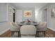 Virtually staged dining room with a modern table, chairs, elegant setting, and contemporary artwork creating an inviting atmosphere at 821 Cabaniss Dr, Shelby, NC 28150