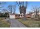 Brick home with an attached garage and concrete driveway at 821 Cabaniss Dr, Shelby, NC 28150