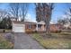 Brick home with an attached garage, concrete driveway and covered porch at 821 Cabaniss Dr, Shelby, NC 28150