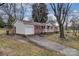 View of the brick home with attached garage and concrete driveway at 821 Cabaniss Dr, Shelby, NC 28150