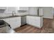 Updated kitchen featuring white cabinets, stainless steel dishwasher, granite countertops, and a stylish subway tile backsplash at 821 Cabaniss Dr, Shelby, NC 28150