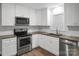 Updated kitchen with stainless appliances, quartz countertops, and white subway tile at 821 Cabaniss Dr, Shelby, NC 28150