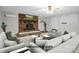 Bright living room with a brick fireplace, large windows and neutral paint, virtually staged for inspiration at 821 Cabaniss Dr, Shelby, NC 28150