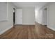Spacious living room with wood-look floors, neutral paint, white trim, and ample natural light from the large window at 821 Cabaniss Dr, Shelby, NC 28150