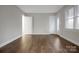 Open living room with wood flooring, natural light, and neutral walls at 821 Cabaniss Dr, Shelby, NC 28150