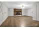 Bright and spacious living room with laminate floors, a brick fireplace, and modern touches, creating an inviting atmosphere at 821 Cabaniss Dr, Shelby, NC 28150
