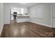 Open-concept living space showcasing wood-look floors and bright natural light with modern fixtures and neutral wall colors at 821 Cabaniss Dr, Shelby, NC 28150