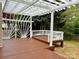 Spacious backyard deck with a pergola, creating a shaded outdoor living area at 8812 Glenover Cir, Charlotte, NC 28269