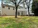 Exterior view of a backyard featuring a deck, white pergola, trees and lawn at 8812 Glenover Cir, Charlotte, NC 28269