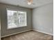 Neutral bedroom with a large window providing ample natural light and exterior views at 8812 Glenover Cir, Charlotte, NC 28269