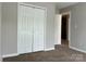 Bedroom with carpeted floor and white closet doors at 8812 Glenover Cir, Charlotte, NC 28269