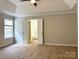 Bedroom featuring carpeted flooring and tray ceiling at 8812 Glenover Cir, Charlotte, NC 28269