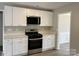 Kitchen with white cabinets, stainless steel appliances, quartz countertops, and hardwood floors at 8812 Glenover Cir, Charlotte, NC 28269