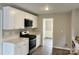 Kitchen with white cabinets, stainless steel appliances, quartz countertops, and hardwood floors at 8812 Glenover Cir, Charlotte, NC 28269