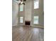 Living room with hardwood floors, grey walls, a fireplace, and lots of natural light from many windows at 8812 Glenover Cir, Charlotte, NC 28269