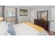 Sun-filled bedroom with wooden dresser and neutral decor at 921 Ambassador St # 1, Charlotte, NC 28208