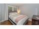 Bright bedroom features a large window, hardwood floors, and a stylishly made bed at 921 Ambassador St # 1, Charlotte, NC 28208