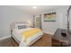 Bright bedroom with Queen bed, hardwood floors and neutral decor at 921 Ambassador St # 1, Charlotte, NC 28208