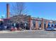 A charming exterior view of Rhino Market & Deli, a brick commercial building with parking and outdoor seating at 921 Ambassador St # 1, Charlotte, NC 28208