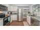 Well-lit kitchen featuring stainless steel appliances, granite countertops, and ample storage at 921 Ambassador St # 1, Charlotte, NC 28208
