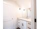 Bright bathroom features a granite-topped vanity with white cabinetry and a decorative sconce lighting fixture at 0 6Th Nw St, Hickory, NC 28601